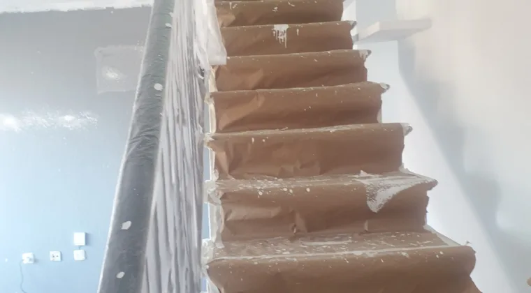 Escalera de comunidad con el suelo y la barandilla protegidos